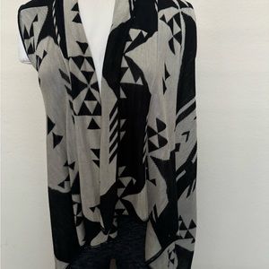 Knit wrap light weight black and tan. Sleeveless or wrap over Made in USA